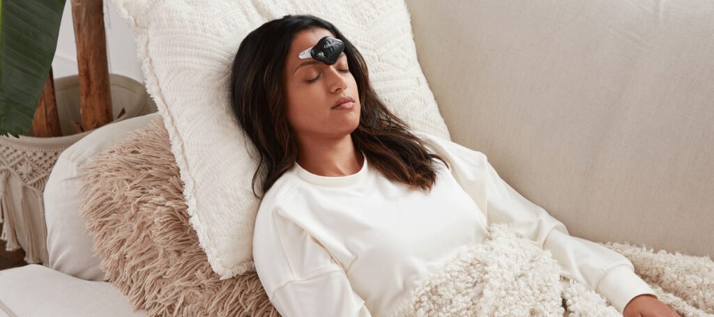 women laying down with cefaly connected device on women laying down with cefaly connected device on