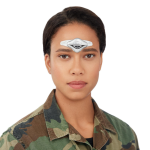 a woman in a military uniform has a CEFALY migraine treatment device on her forehead