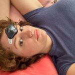 women laying down with cefaly device on forehead